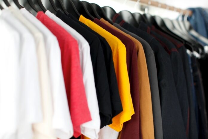 Coloured shirts hanging on rack in store