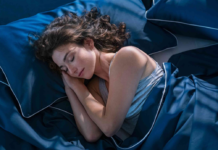 How to Sleep Better and Start Your Morning Right A woman is sound asleep on her comfortable bed after learning some new tips on how to sleep better at night.
